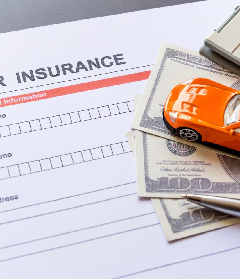 a toy car on a pile of money and documents