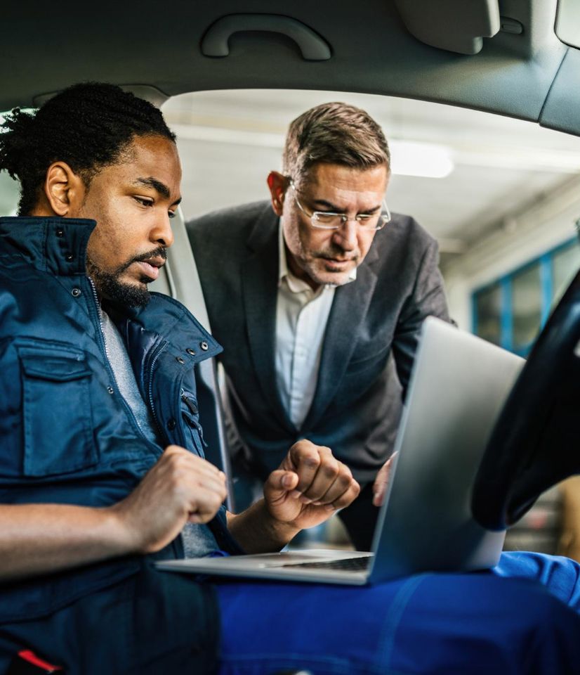 an admin talking to a driver in his car